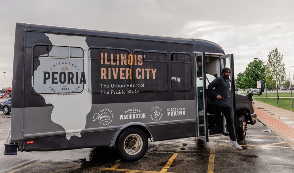 Man getting off the Discover Peoria shuttle bus